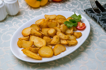 The potatoes wedges on a white plate