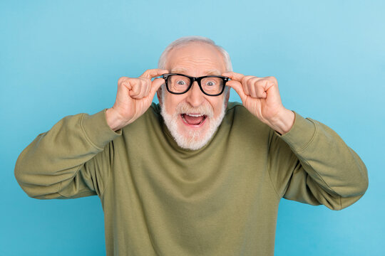 Portrait of attractive crazy cheerful amazed grey-haired man geek touching specs isolated over bright blue color background