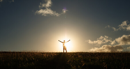 Man with arms up to the morning sky having feelings of hope, and happiness