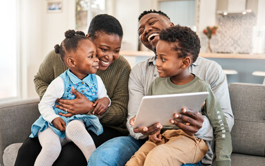 Family friendly movies make the best childhood memories. Shot of a happy young family using a digital tablet on the sofa at home. - Powered by Adobe