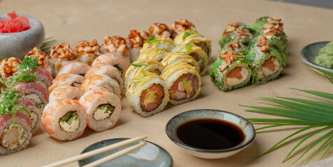 Uramaki rolls with red fish and garnish on a gray background