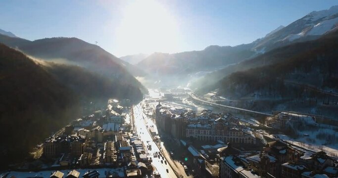 Sochi, Adler, Esto-Sadok 22 February 2022, Aerial view of the city, main road, downtown mall and mountains. Snowboarding resort, winter sports. Morning at krasnaya polyana