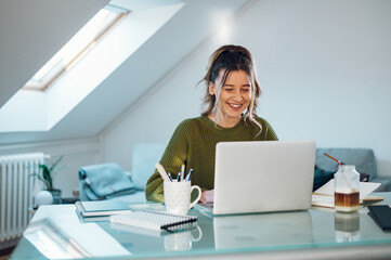 Woman working from a home on her a laptop