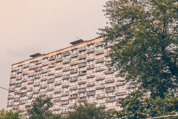 Windows and balconies of the residential building. Old urban obsolete facade of house. The windows...