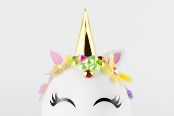 Easter unicorn head egg isolated on white background. Happy easter banner. Kids activity inspiration. Greeting card or poster. Copy space for text