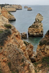 Fototapeta na wymiar Rock islets and cliffs-Praia da Marinha Beach. Lagoa-Portugal-190