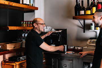 Two waiters working together while talking. Waiter giving an order to his co-worker.