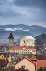 Romania, Dumitra, Evangelical Church, today the Orthodox Church “St. Apostle Peter and Paul ”and  Bacon  Tower, April 2022, panoramic view from the cemetery”,