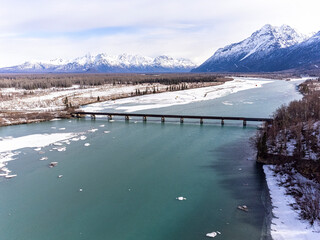 Aerial photo of the Spring ice breakup, along the Knik River, between Anchorage and Wasilla, Alaska. Glenn Highway and bridge.