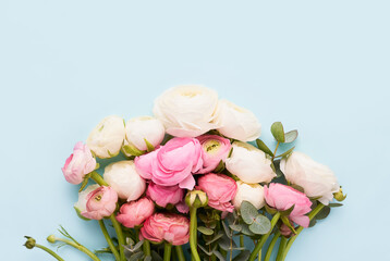 Bouquet of ranunculus flowers on a blue background. Mothers Day, Valentines Day, birthday concept