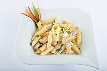 pasta penne with chicken in white sauce with cheese and mushrooms