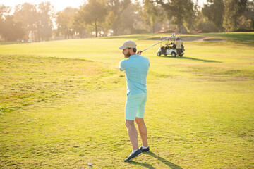 male golf player on professional sunny course with green grass, hobby