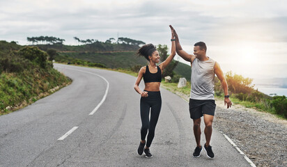 What an amazing run that was. Shot of a sporty young couple high fiving each other while exercising...