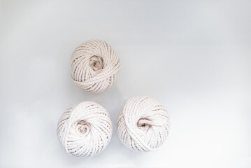 bobbins of light beige pastel color together for weaving macrame needlework