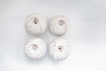bobbins of light beige pastel color for weaving macrame