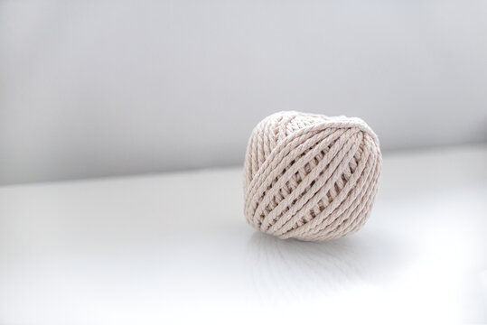 bobbin of light beige pastel color together for weaving macrame needlework