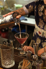 Bartender pooring a cocktail