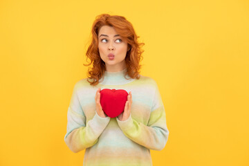 funny redhead girl with red heart on yellow background. valentines day
