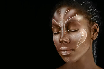 Art photo of Africal woman with tribal ethnic paintings on her face