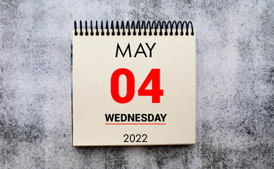 Obraz premium may 4. 4th day of month, calendar date. Stand for desktop calendar on beige wooden background.