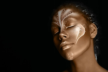 Art photo of Africal woman with tribal ethnic paintings on her face