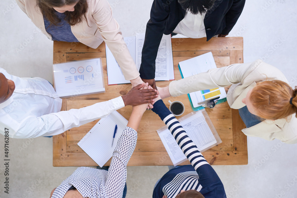 Aufkleber lets do this. high angle shot of a group of colleagues standing around a desk with their hands in a 