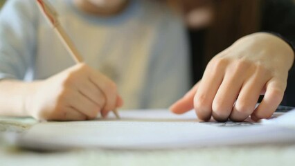 Woman teach son how to do homework at home,school child family education