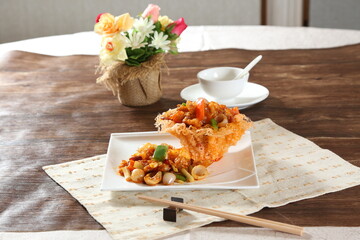 Spicy Calendula Crispy Chicken Treasures in a dish isolated on grey background side view of Hong kong food