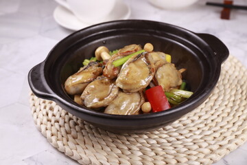 oysters with ginger and shallots in a dish isolated on grey background side view of Hong kong food