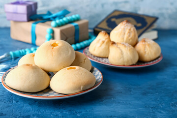 Tasty Arabic cookies on color background
