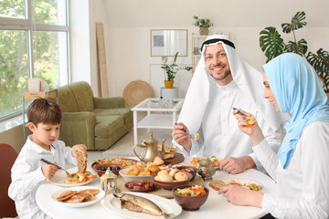 Muslim family having breakfast together. Celebration of Eid al-Fitr