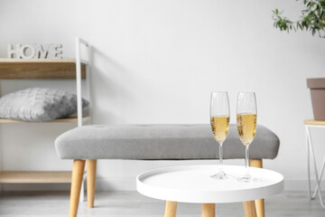 Glasses of champagne on table in modern living room