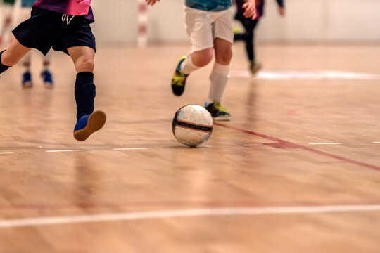 a children futsal player prepares to shoot at goal