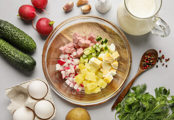 Ingredients for preparing tasty okroshka on grey background, closeup