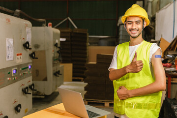 Asian young workers  pointing at his arm with a bandage after receiving the covid-19 vaccine.Vaccination for Essential Workers in healthcare at industrial factory.