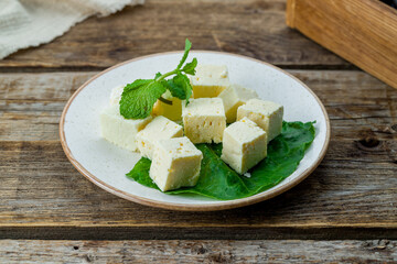 cheese cubes brinsa, brinza sliced cubes on old wooden table