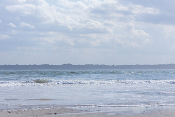Ocean, beach and blue sky with white clouds