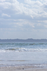 Ocean, beach and blue sky with white clouds