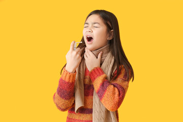 Ill Asian girl with sore throat and inhaler on color background - obrazy, fototapety, plakaty