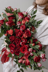 Large bouquet of red roses with ruscus