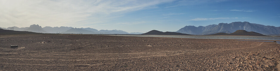 What will you do to save water. Shot of a desolate landscape during the day with a small dried out...
