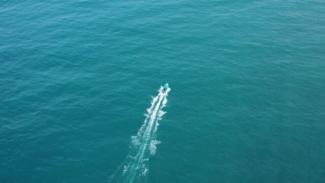 Aerial view of a motorboat sailing in the ocean near Bentota Sea Beach, Sri Lanka.