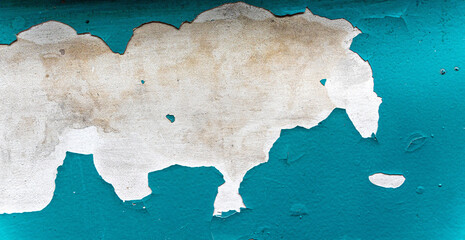 Peeling paint on the wall. Panorama of a concrete wall with old cracked peeling paint.