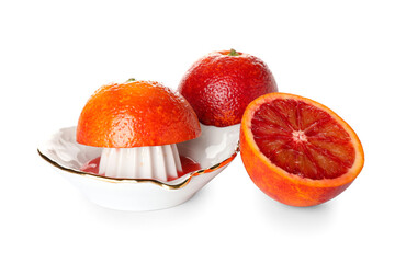 Ceramic juicer and grapefruits on white background