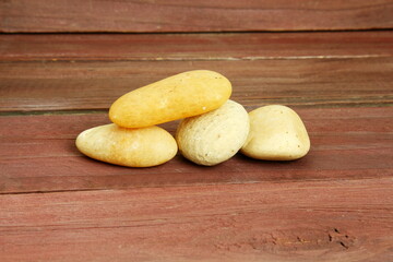 set of beautiful white natural pebble stone texture on wooden background