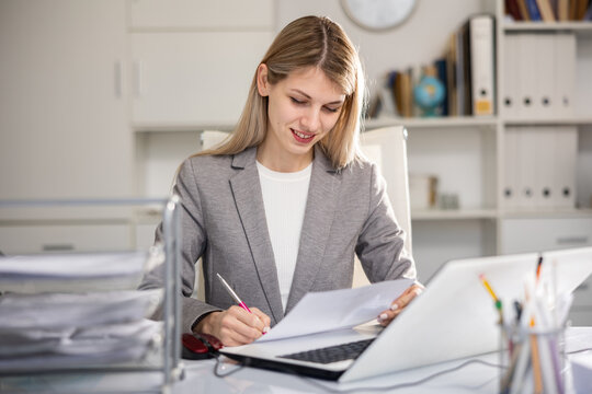 Young caucaisan businesswoman doing her daily work in office.