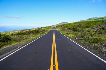 Straight asphalt road of the Piilani Highway in the center of Maui island above Wailea-Makena, Hawaii