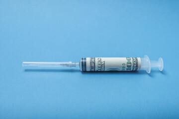 A syringe wrapped in a dollar.