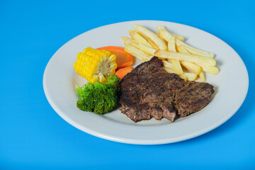 Rib eye with with fries and vegetables