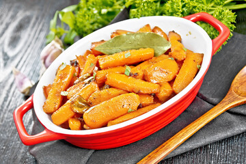 Carrots fried in pan on black board